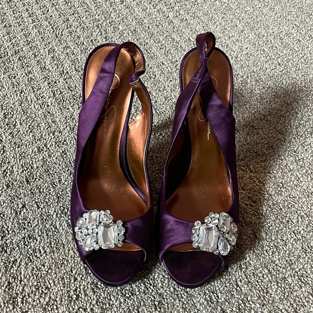 These have never been. Peep toe, purple satin-like heels by Jessica Simpson.